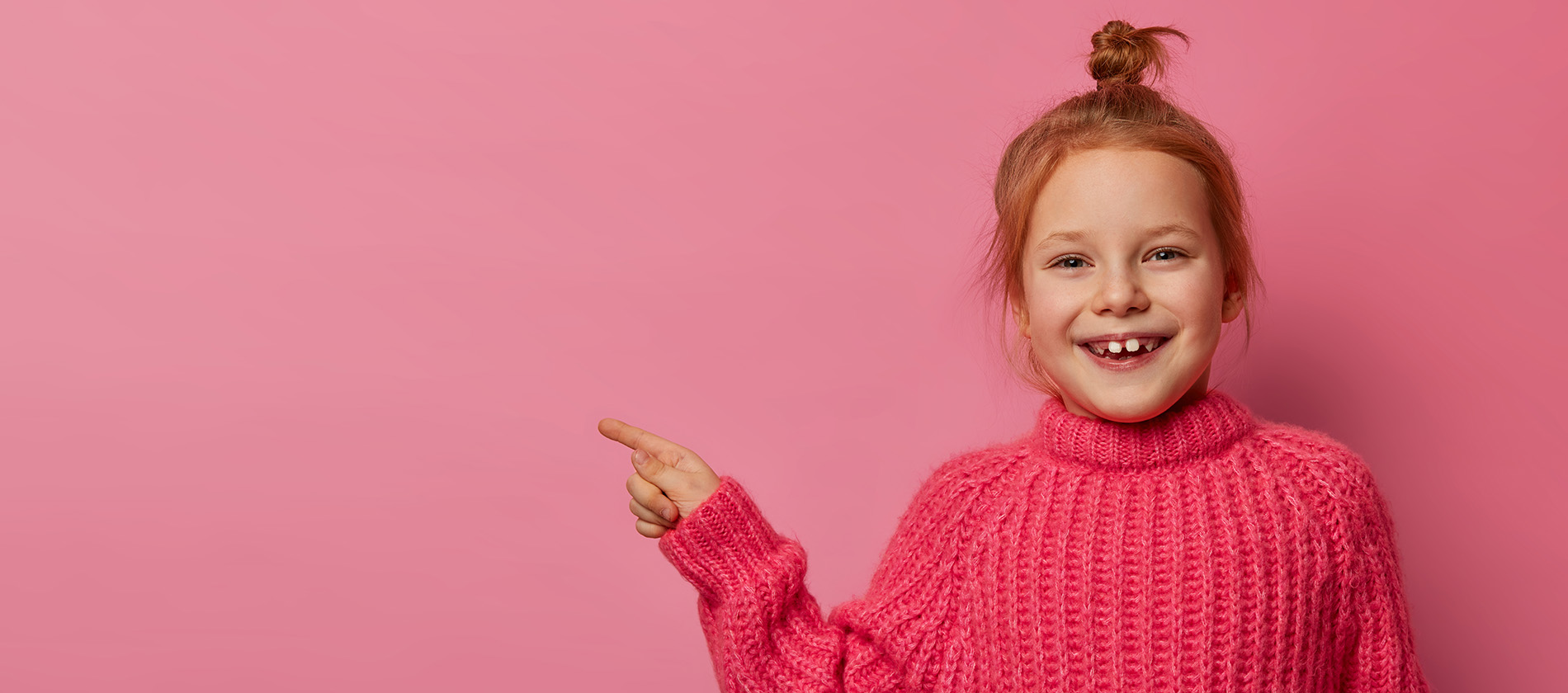 Happy Foxy Girl With Hair Bun Smiles Positively Shows Right Direction 9433